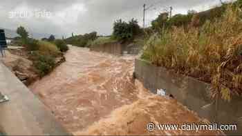 Wild storms trigger 'extraordinary danger' red alert warning to stay indoors in Spanish tourism hotspot as flash floods turn roads into raging rivers