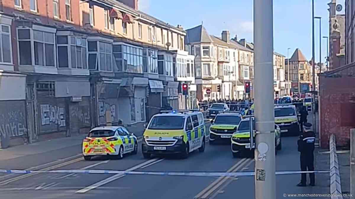 Manhunt underway as armed police bring Blackpool street to standstill and 'find dead dog'