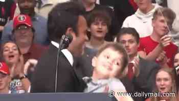 Humiliating moment GOP gubernatorial candidate Vivek Ramaswamy almost drops young boy as he struggles to pick him up during rally