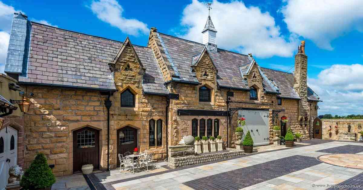 Inside converted 150-year-old coach house with suit of armor on the stairs