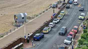 Body of woman 'wearing a wetsuit' is found washed up on popular beach a day after coastguard were seen scouring the area