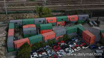 Shipping container village hailed as a 'dream for all homeless people' is making life a 'living hell' for neighbours - who claim residents are trespassing on their £500,000 properties and women are too scared to go out alone