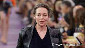 Olivia Colman ties back her new long grey hair as she walks the runway alongside ab-flashing Gigi Hadid at Paris Fashion Week's Miu Miu show
