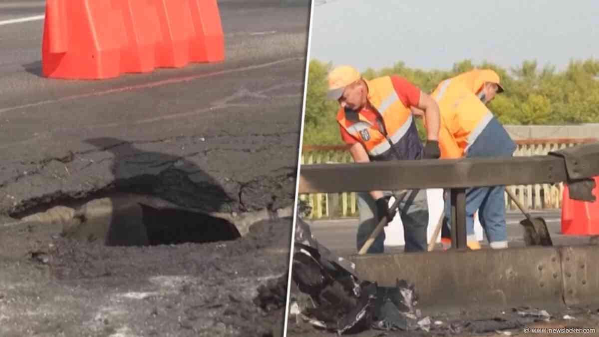 Oekraïners ruimen puin na Russische aanval op brug in Kiev