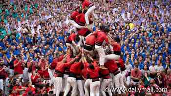 A competition with high stakes! Thousands come together for traditional Spanish Castells event that sees crowds battle to build the highest human tower