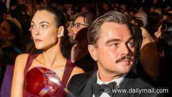Leonardo DiCaprio tries to stay under the radar as he and girlfriend Vittoria Ceretti party with Lenny Kravitz