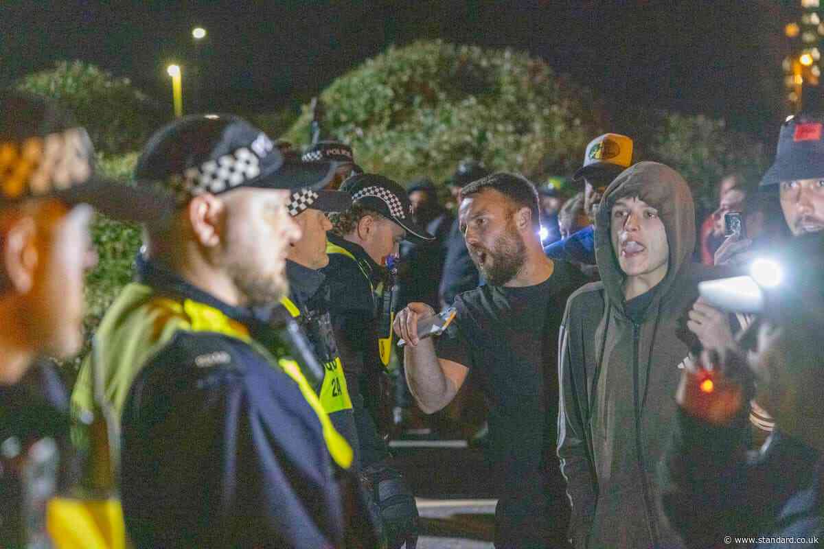 Protesters clash with police and flares set off as migrants arrive in Gosport on RNLI boats