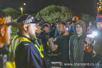 Protesters clash with police and flares set off as migrants arrive in Gosport on RNLI boats