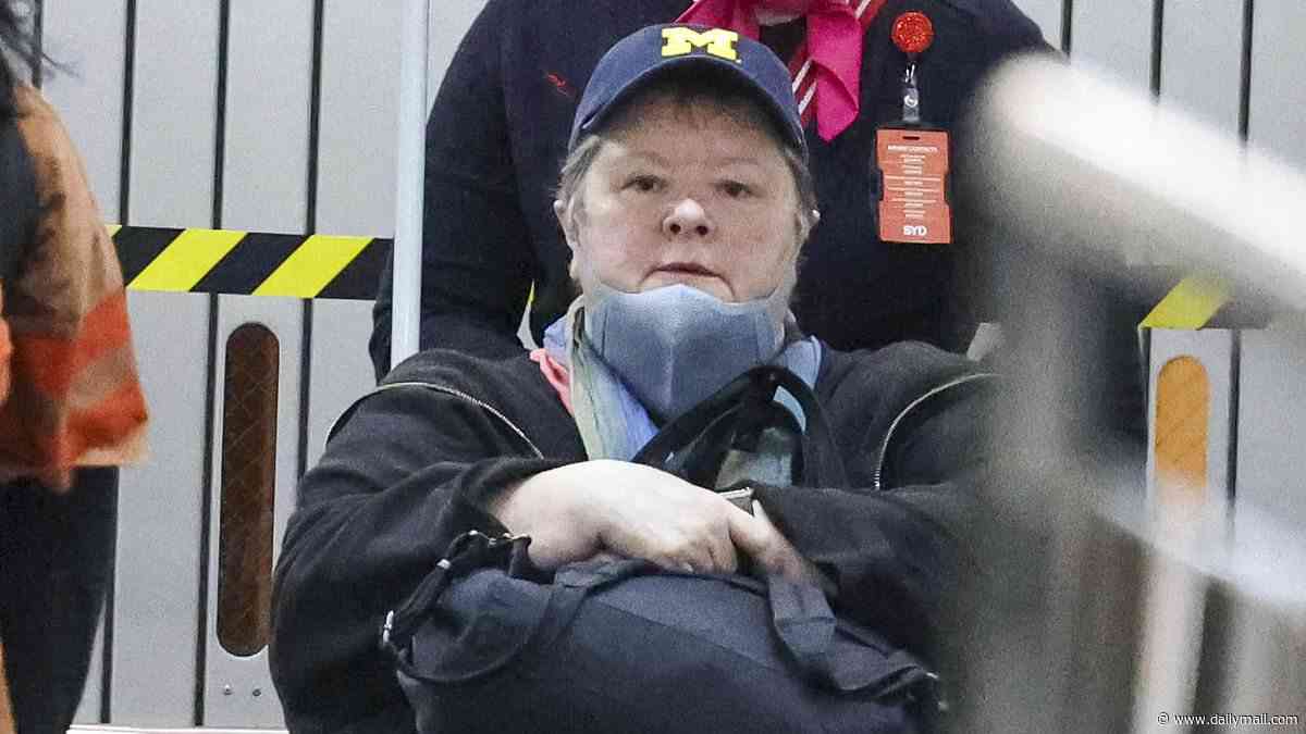 Magda Szubanski arrives at Sydney Airport in a wheelchair and wearing mask after revealing that her rare cancer is 'incurable'