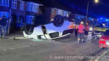 Car flips on roof along residential street and woman taken to hospital