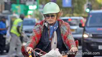 Helena Bonham Carter cycles through a red light while running errands on her £3000 electric bike in central London