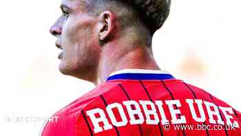 Why does Robbie Ure have Robbie Ure on his Scotland shirt?