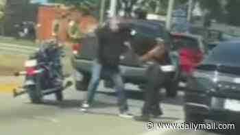 White man filmed yanking black woman by her hair and beating her with belt during terrifying road rage attack