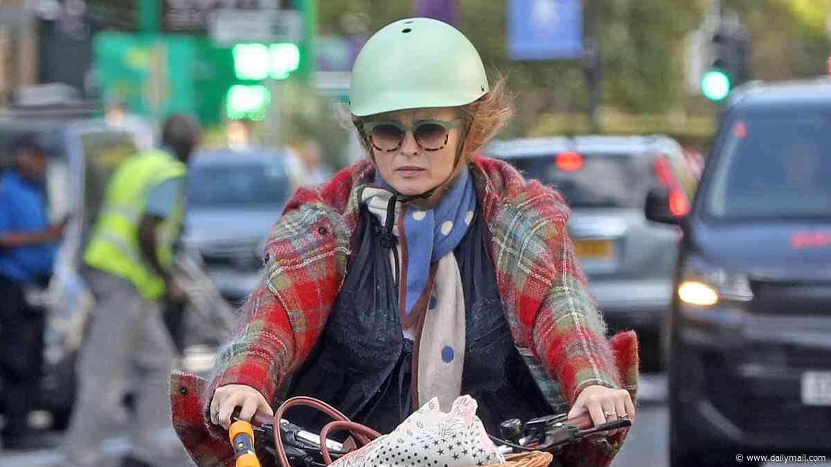 Helena Bonham Carter cycles through a red light while running errands on her £3,000 electric bike in central London