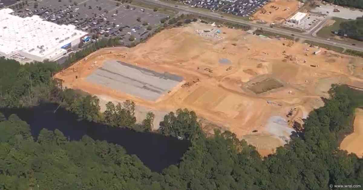 Body found partially submerged in water behind Sanford Walmart