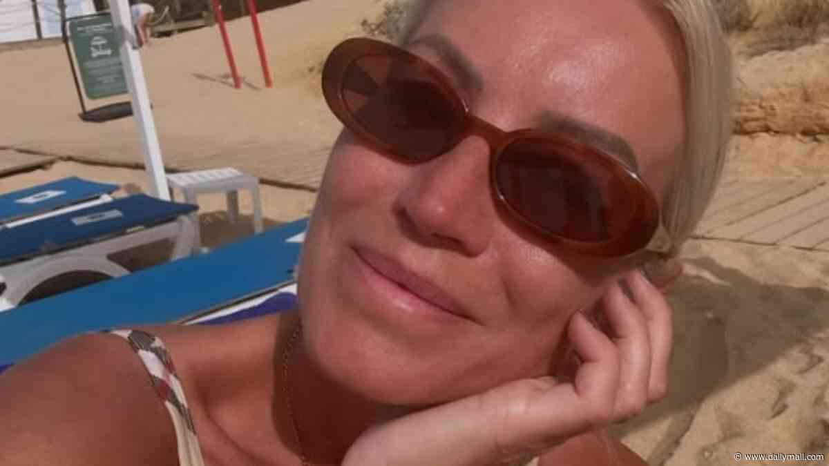 Denise Van Outen slips into a Burberry swimsuit after jetting off to Portugal on holiday