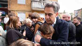 Ed Miliband embraces Ukrainians at scene of Putin bombing raid that killed 22 as Britain announces new sanctions on Russia