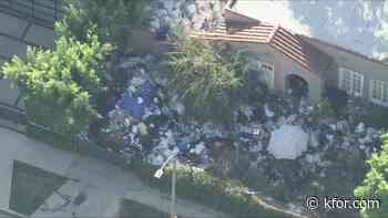 L.A. neighborhood's infamous ‘trash house’ buried in garbage again