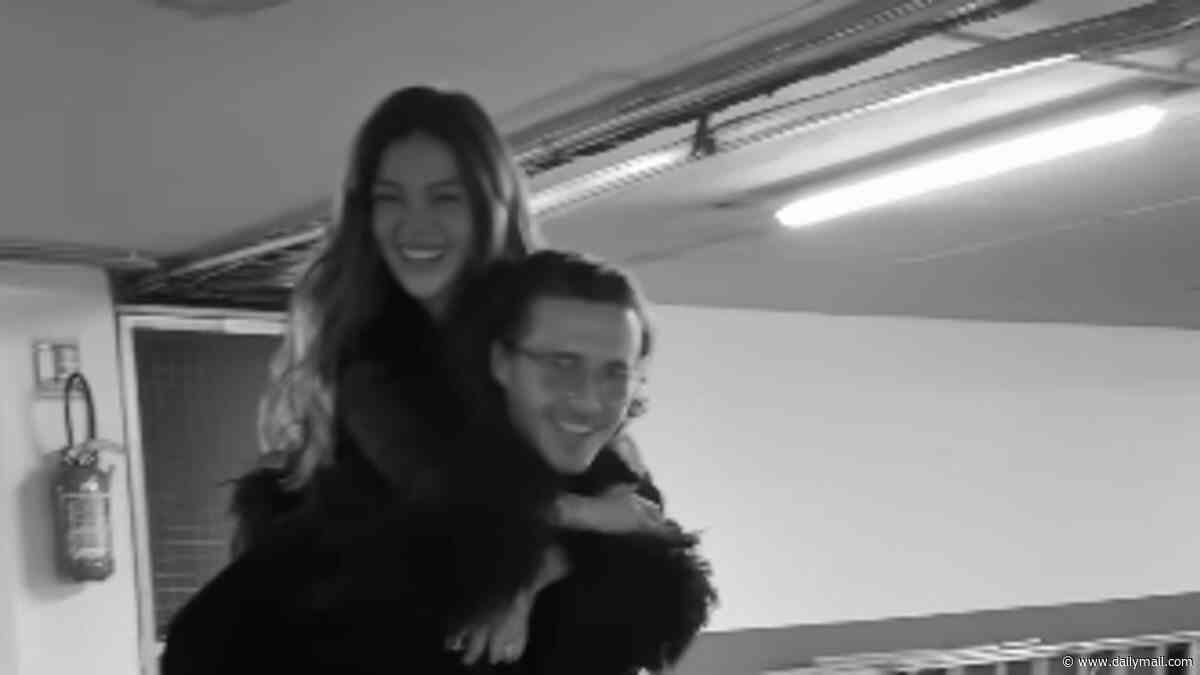 Brooklyn Beckham carries his 'world' Nicola Peltz on his back in loved-up clip after reigniting family feud with parents David and Victoria