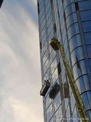 London skyscraper drama as window cleaners rescued from 15th floor