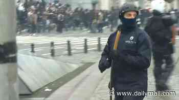 Student riots spread to Belgium as hundreds of hooded protesters clash with cops sparking 'total chaos' in Brussels