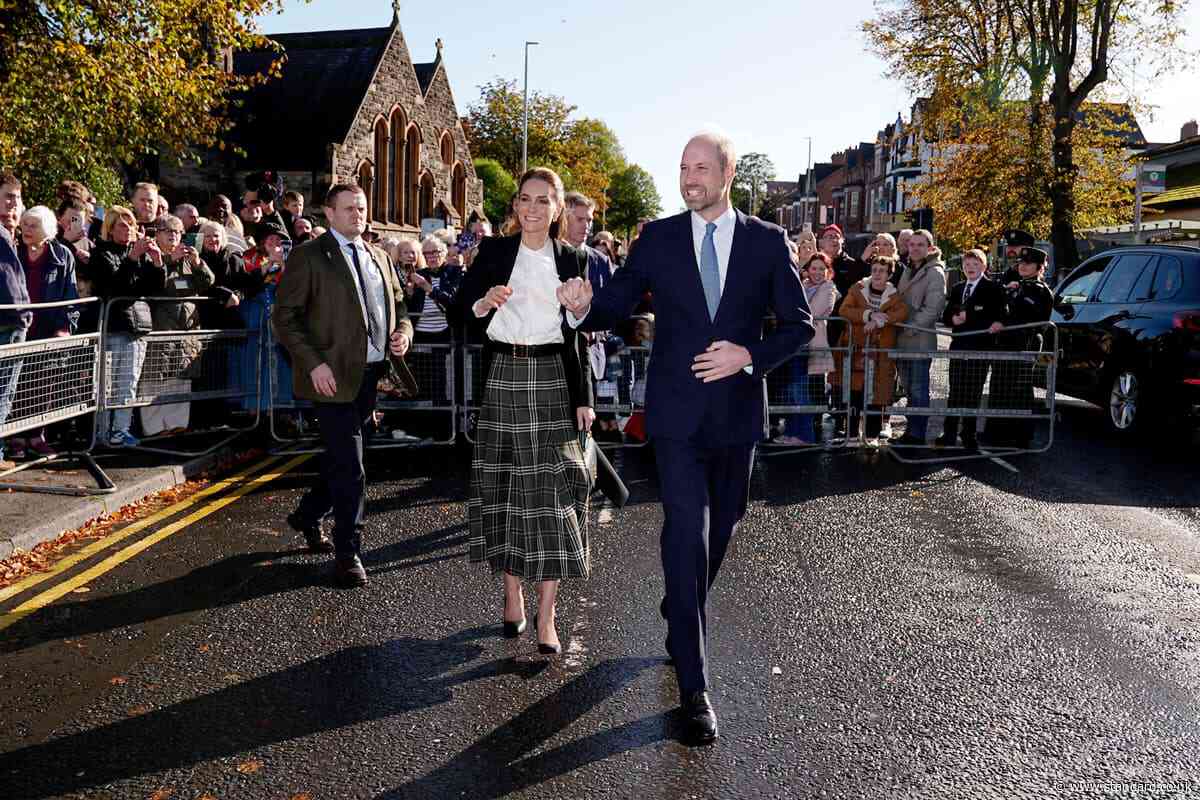 William and Kate dodge rain showers to meet community centre supporters
