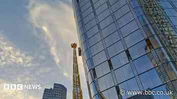 Window cleaners stuck on 15th floor cradle rescued