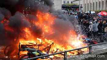 Student riots spread to Belgium as hundreds of hooded protesters clash with police sparking 'total chaos' in Brussels