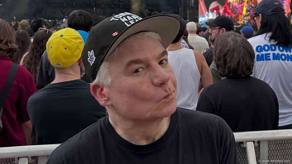 Mike Myers, 63, looks younger than ever as he wears an edgy 'Fight Fascism' T-shirt at politically-charged rock concert