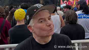 Mike Myers, 63, looks younger than ever as he wears an edgy 'Fight Fascism' T-shirt at politically-charged rock concert