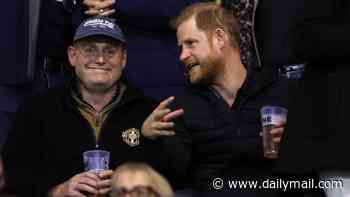 Prince Harry enjoys a beer in the stands at rugby match as he and Meghan settle back into life in the UK