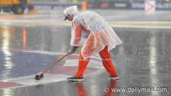 Think YOUR job is a thankless task? Funny moment Singapore workers try to defy the elements and sweep away torrential downpouring threatening the Grand Prix