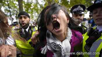 Scuffles break out between masked protesters and police on pro-Palestinian march through centre of London just days after October 7 anniversary