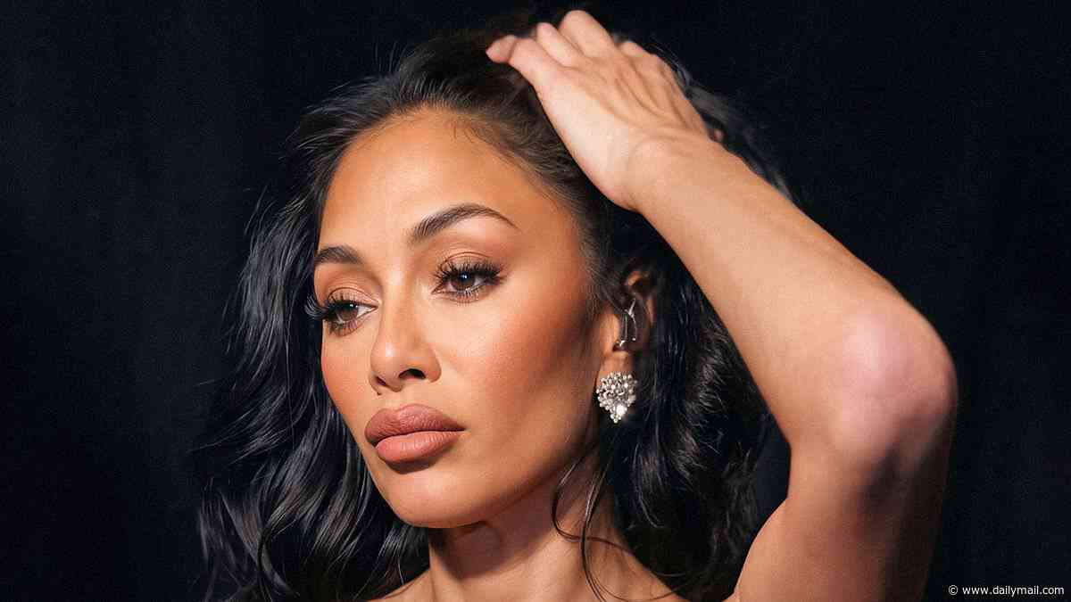 Nicole Scherzinger puts on a sultry display in a red look as she poses backstage at the Pussycat Dolls tour - after suffering nasty burns