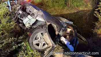 Driver rescued after car submerged into brook