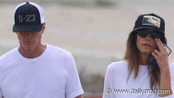 Cindy Crawford and Rande Gerber hold hands on beach in somber outing three weeks after son Presley died aged 27 at rehab facility