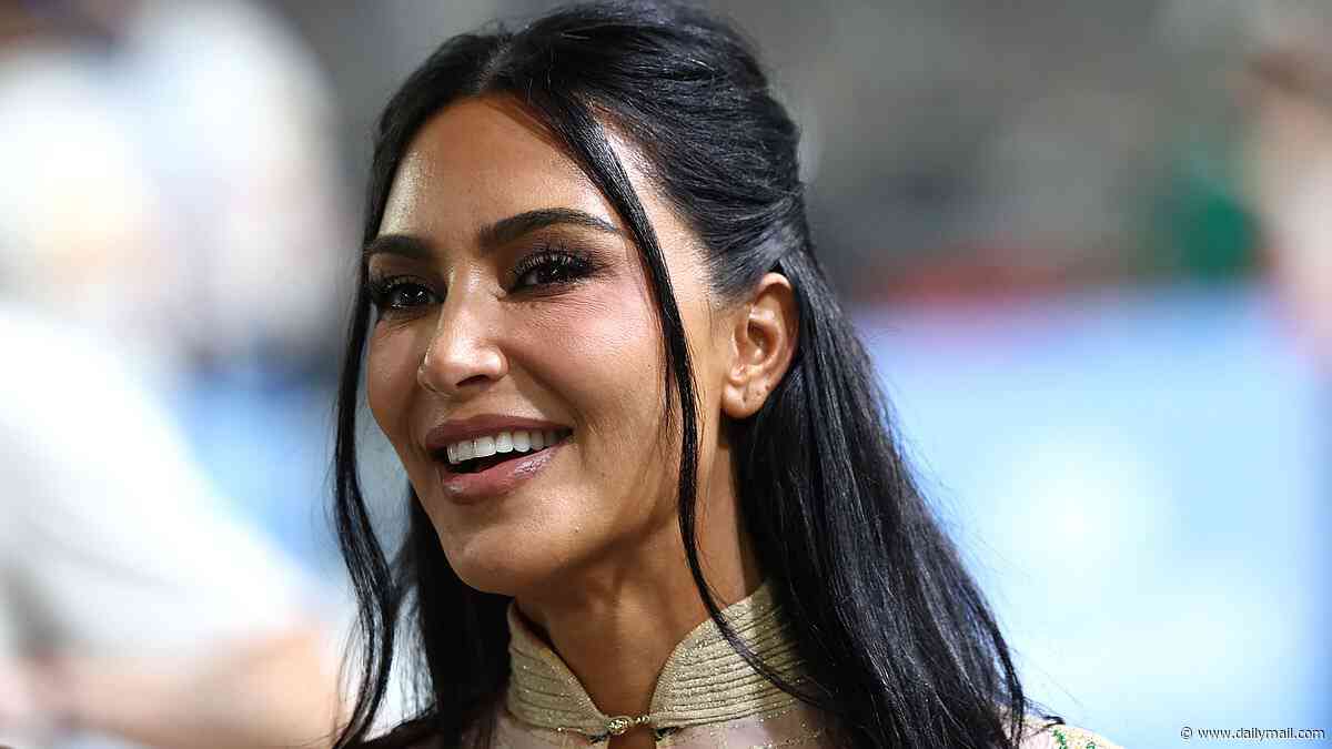 Kim Kardashian walks the Singapore Grand Prix paddock in floral corset dress and sky-high heels as she prepares to cheer on Lewis Hamilton