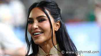 Kim Kardashian walks the Singapore Grand Prix paddock in floral corset dress and sky-high heels as she prepares to cheer on Lewis Hamilton