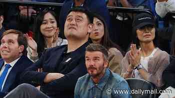 David Beckham is dwarfed by 7ft 6in basketball player Yao Ming as he enjoys game in China