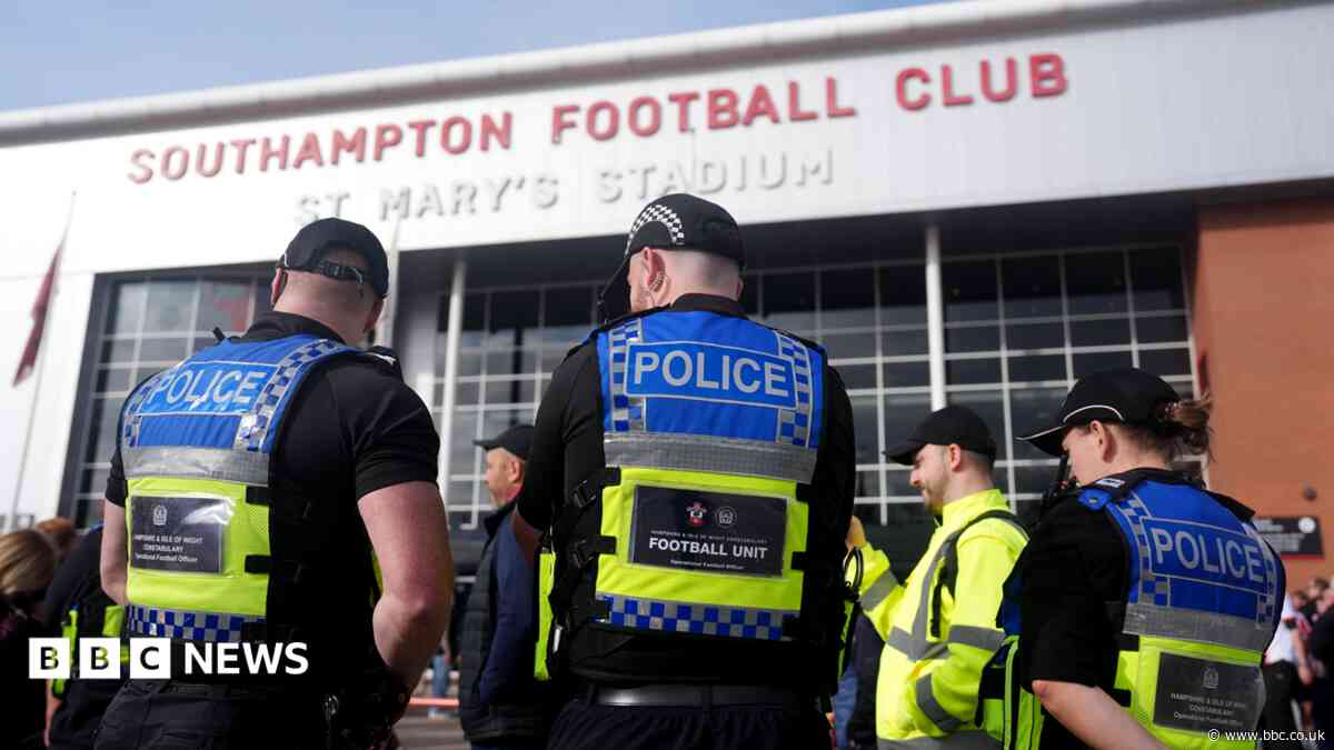 Officer injured as football fans pull down barriers