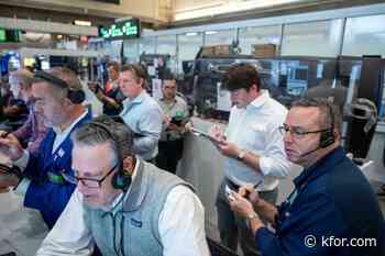 US stocks hover near their latest record in mixed trading on Wall Street