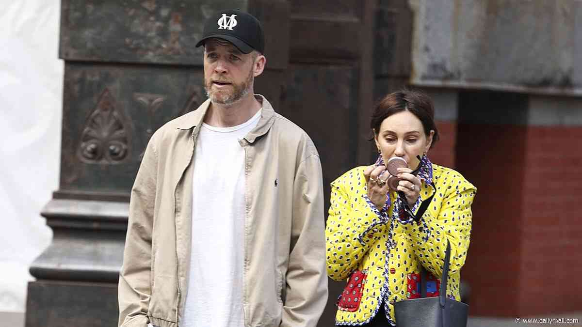 Zoë Foster Blake wears a quirky outfit as she does her makeup up on the streets of New York during stroll with husband Hamish - after couple arrive for Andy Lee and Rebecca Harding's wedding