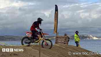 Thousands line promenade for beach motocross