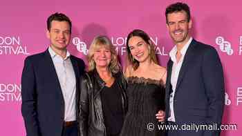 Lily James makes a rare appearance with her mother and 'very handsome brothers' at the London Film Festival