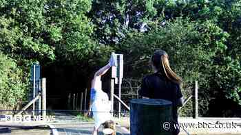 Children filmed playing on level crossing