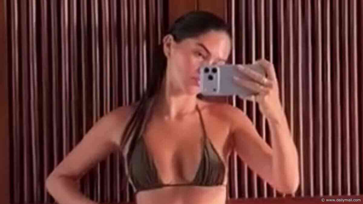 Romeo Beckham's girlfriend Kim Turnbull shows off her model figure in a barely-there bikini as she poses for sizzling video