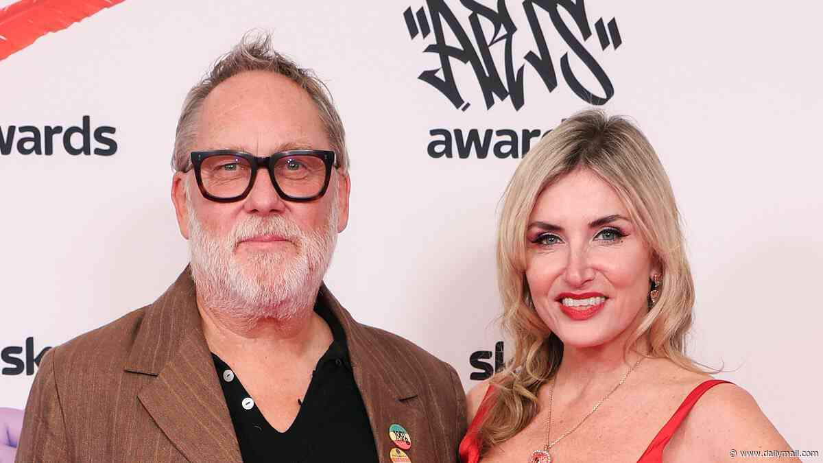 Vic Reeves, 67, makes his first public appearance since being rushed to hospital after collapsing at a wedding as he is supported by his wife Nancy Sorrell at the Sky Arts Awards