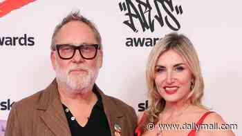 Vic Reeves, 67, makes his first public appearance since being rushed to hospital after collapsing at a wedding as he is supported by his wife Nancy Sorrell at the Sky Arts Awards
