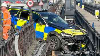 Can't park there, mate! Shocked ferry passengers spot police car dangling from pier