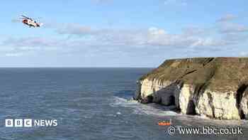 Three men rescued after rising tide cuts them off